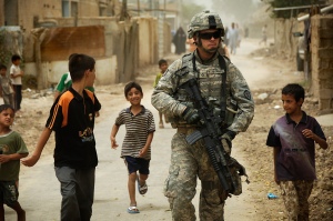  Iraqi children gather around as U.S. Army Pfc. Shane Bordonado patrols the streets of Al Asiriyah, Iraq, on Aug. 4, 2008. Bordonado is assigned to 2nd Squadron, 14th Cavalry Regiment, 25th Infantry Division. DoD photo by Spc. Daniel Herrera, U.S. Army. (Released)